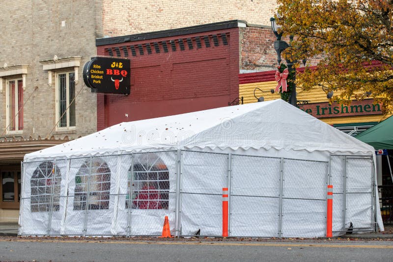 Everett, WA - USA - 11/27/2020: Outdoor Dining Tent outside Pub for Customers to Safely Eat and Drink During Covid-19 Pandamemic. Everett, WA - USA - 11/27/2020: Outdoor Dining Tent outside Pub for Customers to Safely Eat and Drink During Covid-19 Pandamemic