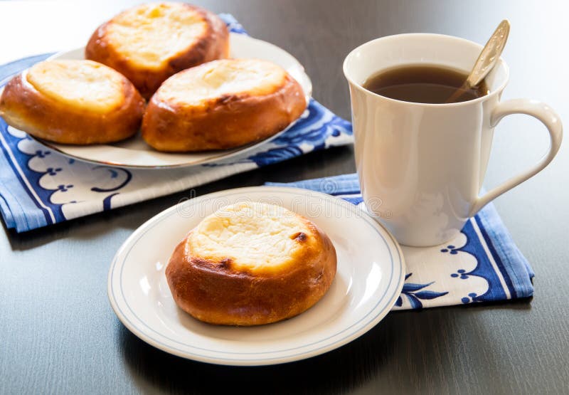 Cottage cheese pastry pies, vatrushka in Russian cuisine. and cup of tea. selective focus. Cottage cheese pastry pies, vatrushka in Russian cuisine. and cup of tea. selective focus