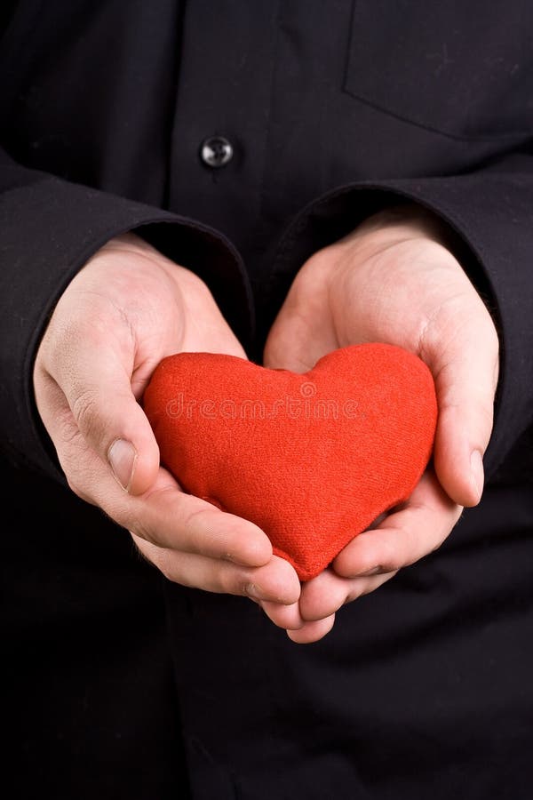 Man holding heart in hands. Man holding heart in hands