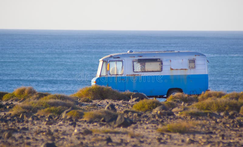 An old rusty vintage surfing camping van on the coast. An old rusty vintage surfing camping van on the coast.