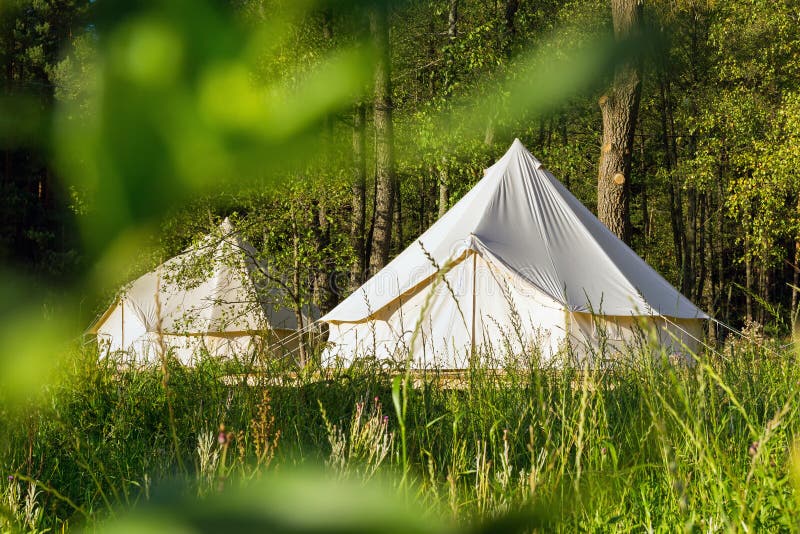 Camping canvas bell tents outdoors at forest. Camping canvas bell tents outdoors at forest