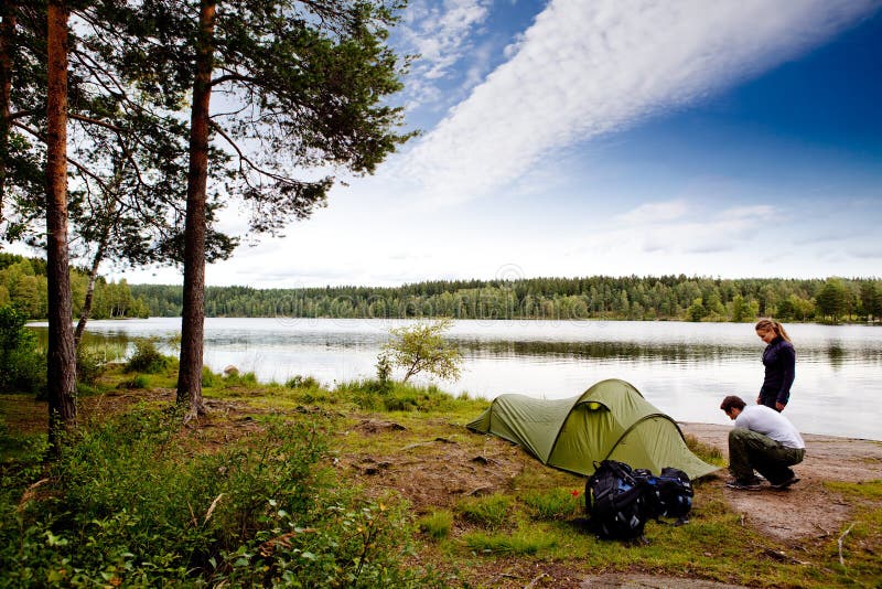 A couple camping on a lake landscape. A couple camping on a lake landscape