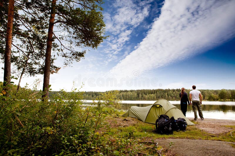 A couple camping on a lake landscape. A couple camping on a lake landscape