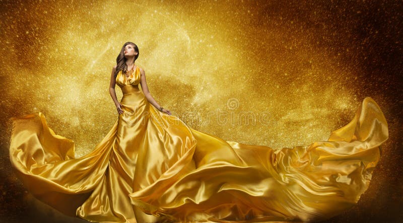 金子时装模特儿礼服，妇女金黄丝绸褂子流动的织品