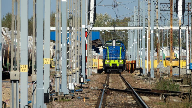 Electrified Railway with metal structures and poles (Metal t-designs). Railway junction, rail depot and electric locomotive. Electrified Railway with metal structures and poles (Metal t-designs). Railway junction, rail depot and electric locomotive