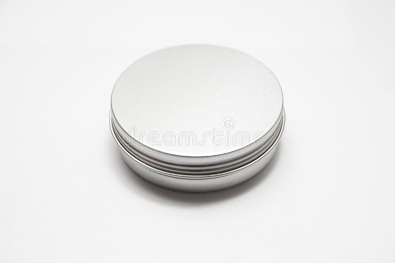 Lip balm in the round metallic tins isolated on the white background. Lip balm in the round metallic tins isolated on the white background