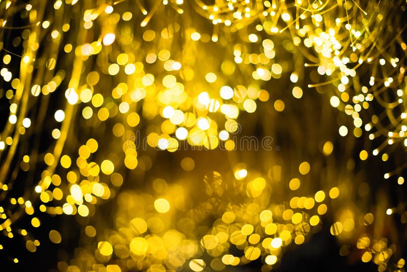 金抽象bokeh背景圣诞节背景 与bokeh defocused光和星的欢乐抽象背景 免版税库存照片 金抽象bokeh背景圣诞节背景 与bokeh defocused光和星的欢乐抽象背景 免版税库存照片