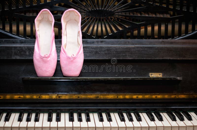 Pink pointe on the black old piano. Pink pointe on the black old piano