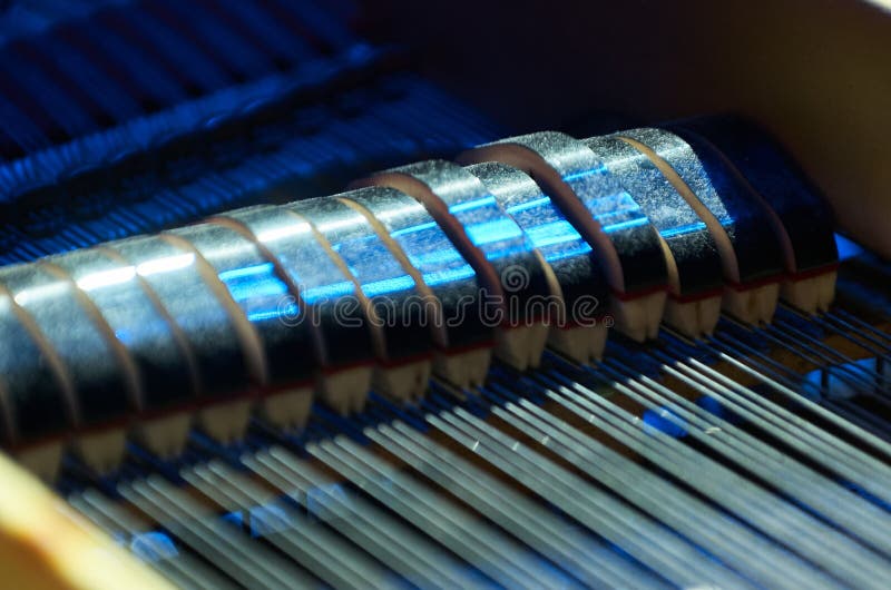 This highly detailed macro photograph reveals a microcosmic world inside the piano. shot from a narrow side view, neon blue lines trace along spines and around coils inside the instrument. Small mechanical details come into focus, illuminated by the heated wires which give this interior landscape an otherworldly glow. The image isolates beauty in minutiae, not typically seen. Ideal for contexts. This highly detailed macro photograph reveals a microcosmic world inside the piano. shot from a narrow side view, neon blue lines trace along spines and around coils inside the instrument. Small mechanical details come into focus, illuminated by the heated wires which give this interior landscape an otherworldly glow. The image isolates beauty in minutiae, not typically seen. Ideal for contexts