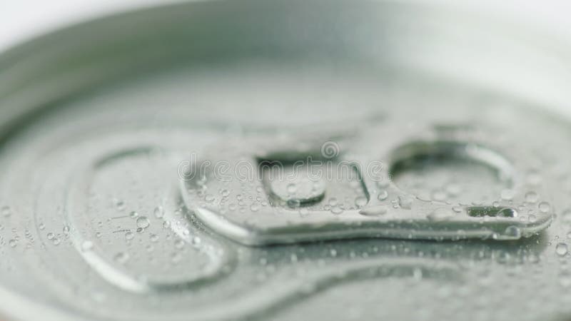 The lid of the aluminum can from the carbonated drink is covered with droplets of condensate. Cool drinks concept. The lid of the aluminum can from the carbonated drink is covered with droplets of condensate. Cool drinks concept.