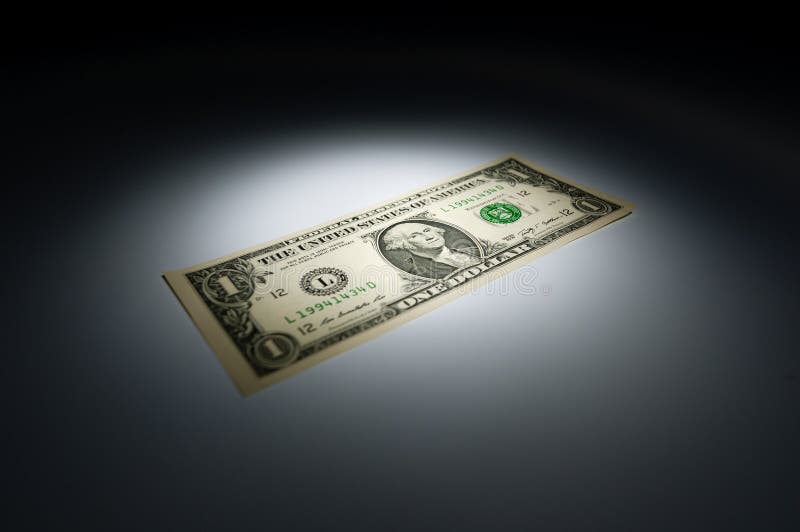 United states one dollar bank note on dark background under spot light. United states one dollar bank note on dark background under spot light