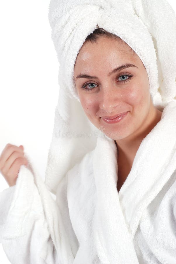 Woman in a bath robe and white towel on white. Woman in a bath robe and white towel on white