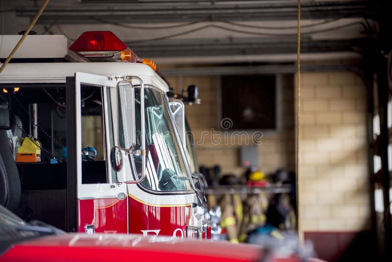 A closeup shot of a firetruck with an open door and a blurred background. A closeup shot of a firetruck with an open door and a blurred background