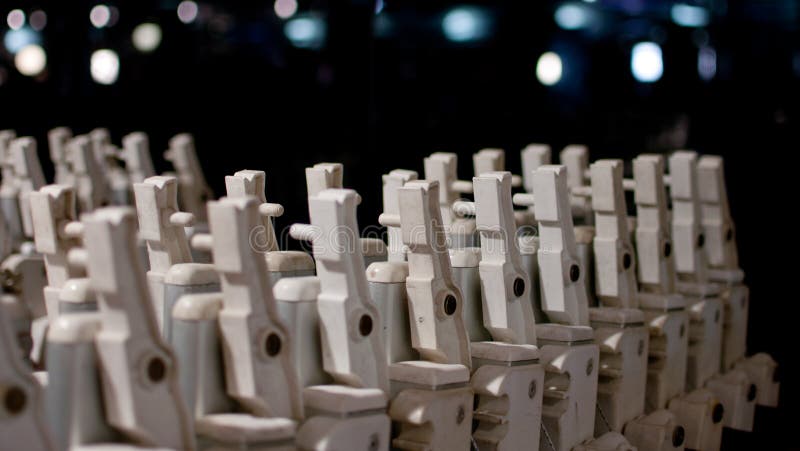 A series of closed deckchair in black background, this is the secret life of a family of deckchairs, when the games are finished. A series of closed deckchair in black background, this is the secret life of a family of deckchairs, when the games are finished