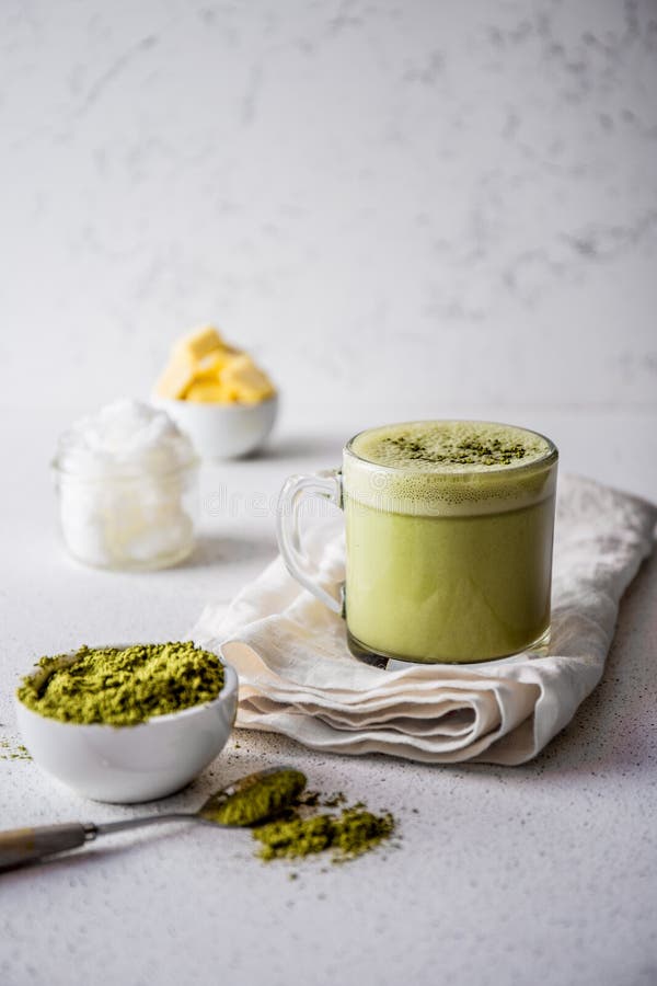 BULLETPROOF MATCHA. Ketogenic keto diet hot drink. Tea matcha blended with coconut oil and butter. Cup of bulletproof matcha and ingredients on white background. BULLETPROOF MATCHA. Ketogenic keto diet hot drink. Tea matcha blended with coconut oil and butter. Cup of bulletproof matcha and ingredients on white background.