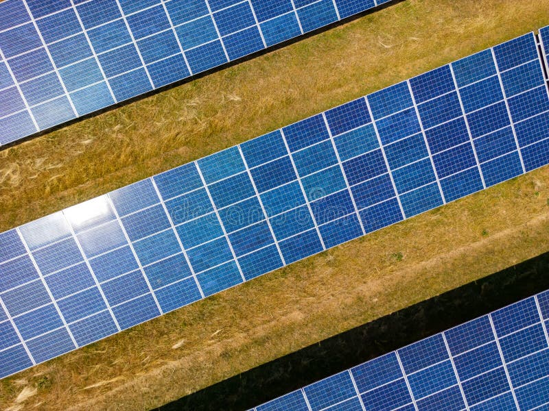 A solar power plant from above with many blue solar cells for environmentally friendly energy production in Germany. A solar power plant from above with many blue solar cells for environmentally friendly energy production in Germany