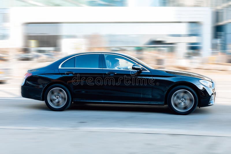 Moscow, Russia - march 2022: Mercedes E Class W213 car in motion on the city street on sunny spring day. Moscow, Russia - march 2022: Mercedes E Class W213 car in motion on the city street on sunny spring day