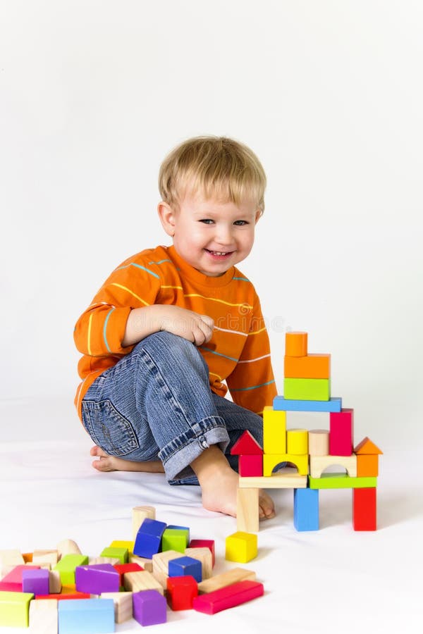 2 years old baby boy playing with wooden blocks. 2 years old baby boy playing with wooden blocks.