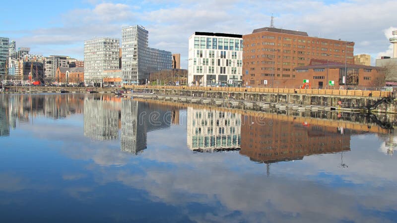 This picture was taken on a lovely very still day in January 2014.The Albert Dock is a complex of dock buildings and warehouses in Liverpool, England. Designed by Jesse Hartley and Philip Hardwick, it was opened in 1846, and was the first structure in Britain to be built from cast iron, brick and stone, with no structural wood. As a result, it was the first non-combustible warehouse system in the world.[1]nnAt the time of its construction the Albert Dock was considered a revolutionary docking system because ships were loaded and unloaded directly from/to the warehouses. Two years after it opened it was modified to feature the world's first hydraulic cranes.[2] Due to its open yet secure design, the Albert Dock became a popular store for valuable cargoes such as brandy, cotton, tea, silk, tobacco, ivory and sugar. However, despite the Albert Dock's advanced design, the rapid development of shipping technology meant that within 50 years, larger, more open docks were required, although it remained a valuable store for cargo. This picture was taken on a lovely very still day in January 2014.The Albert Dock is a complex of dock buildings and warehouses in Liverpool, England. Designed by Jesse Hartley and Philip Hardwick, it was opened in 1846, and was the first structure in Britain to be built from cast iron, brick and stone, with no structural wood. As a result, it was the first non-combustible warehouse system in the world.[1]nnAt the time of its construction the Albert Dock was considered a revolutionary docking system because ships were loaded and unloaded directly from/to the warehouses. Two years after it opened it was modified to feature the world's first hydraulic cranes.[2] Due to its open yet secure design, the Albert Dock became a popular store for valuable cargoes such as brandy, cotton, tea, silk, tobacco, ivory and sugar. However, despite the Albert Dock's advanced design, the rapid development of shipping technology meant that within 50 years, larger, more open docks were required, although it remained a valuable store for cargo.