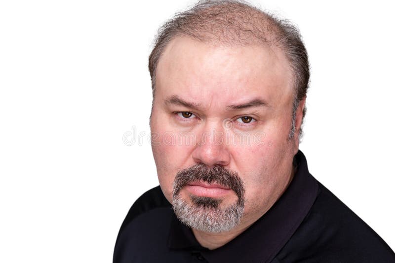 Implacable overbearing middle-aged man looking at the camera with a stern expression and baleful glare, head and shoulders isolated on white. Implacable overbearing middle-aged man looking at the camera with a stern expression and baleful glare, head and shoulders isolated on white