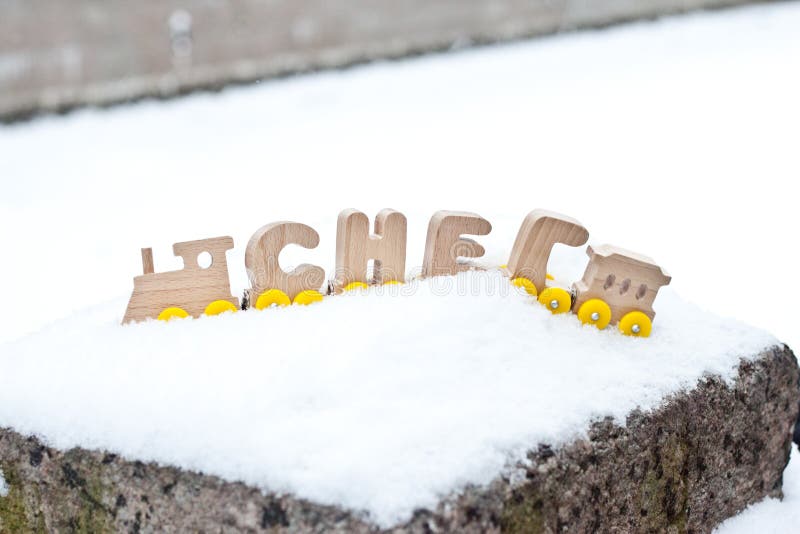 雪冬天词组成由在白色雪的俄语木信件列车车箱 被点燃的背景电灯泡色的装饰诗歌选节假日光 免版税库存图片 雪冬天词组成由在白色雪的俄语木信件列车车箱 被点燃的背景电灯泡色的装饰诗歌选节假日光 免版税库存图片