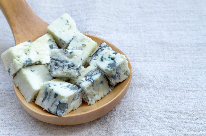 Blue cheese on wooden spoon . Blue cheese on wooden spoon .