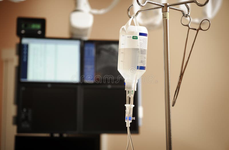 Intravenous drip system on a background of medical appliances. Intravenous drip system on a background of medical appliances