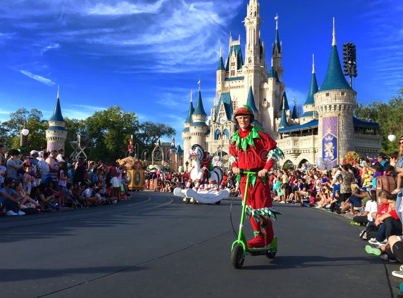 Elf riding scooter at Christmas holiday parade party Walt Disney World Magic Kingdom,Orlando,Florida 2015. Elf riding scooter at Christmas holiday parade party Walt Disney World Magic Kingdom,Orlando,Florida 2015