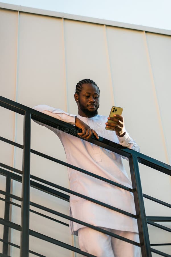 African american man checks cell phone in the street cafe in summer day. Millennial generation and gen z people. Social networks and dating app. African american man checks cell phone in the street cafe in summer day. Millennial generation and gen z people. Social networks and dating app