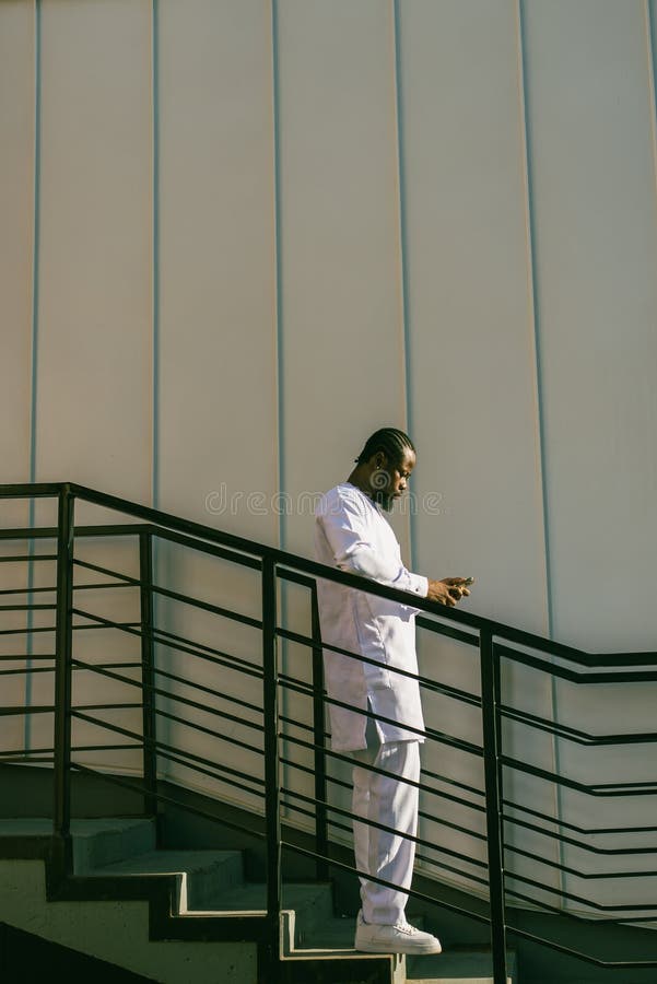 African american man checks cell phone in the street cafe in summer day. Millennial generation and gen z people. Social networks and dating app. African american man checks cell phone in the street cafe in summer day. Millennial generation and gen z people. Social networks and dating app