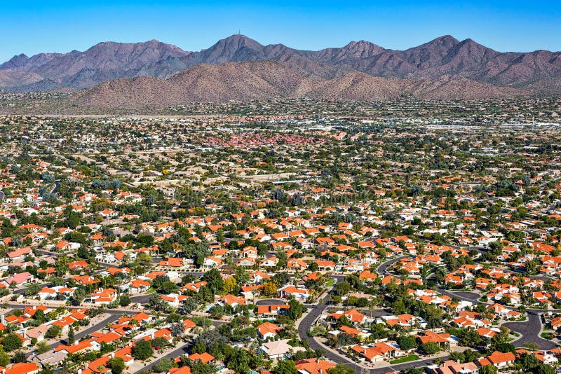 Aerial perspective of an upscale southwest suburban neighborhood with a scenic mountain backdrop. Aerial perspective of an upscale southwest suburban neighborhood with a scenic mountain backdrop
