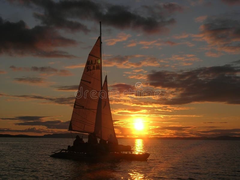 Sailboat at sunset with cloudy sky. Sailboat at sunset with cloudy sky