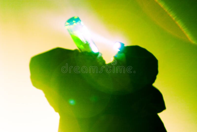 Silhouette of man drinking, shot backlit, visible lens flare. Silhouette of man drinking, shot backlit, visible lens flare.