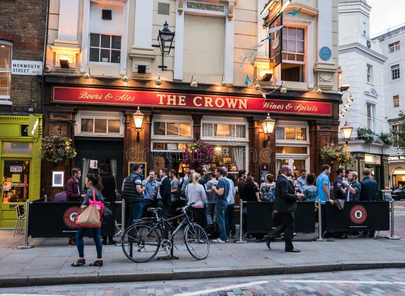 London, England, August 20, 2015: Crowd of drinkers stand outside The Crown pub in Monmouth Street. London, England, August 20, 2015: Crowd of drinkers stand outside The Crown pub in Monmouth Street