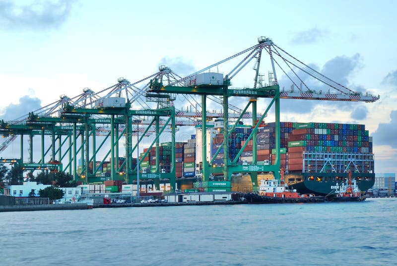 KAOHSIUNG, TAIWAN -- JUNE 2, 2019: Containers are being loaded onto ships in Kaohsiung Port. KAOHSIUNG, TAIWAN -- JUNE 2, 2019: Containers are being loaded onto ships in Kaohsiung Port