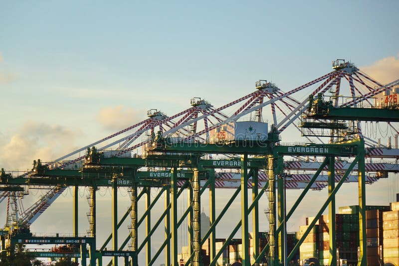 KAOHSIUNG, TAIWAN -- JUNE 2, 2019: Containers are being loaded onto ships in Kaohsiung Port. KAOHSIUNG, TAIWAN -- JUNE 2, 2019: Containers are being loaded onto ships in Kaohsiung Port