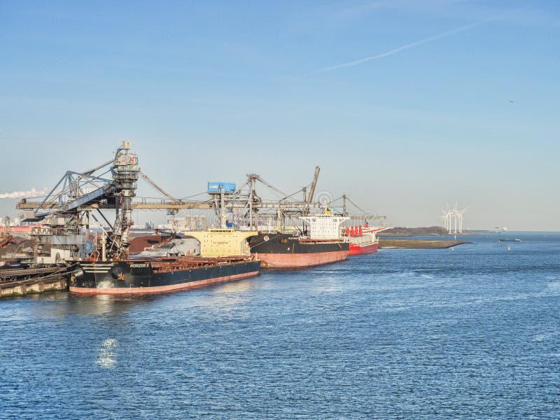 6 April 2018: Rotterdam, Netherlands - Bulk carriers Horizon 2 and Milos Warrior being loaded at Port of Rotterdam on a sunny spring morning with clear blue sky. 6 April 2018: Rotterdam, Netherlands - Bulk carriers Horizon 2 and Milos Warrior being loaded at Port of Rotterdam on a sunny spring morning with clear blue sky.