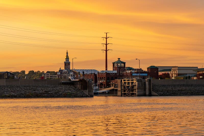 Upper Mississippi on colorful sunset evening at Dubuque with docked river cruise boat in inner harbor. Upper Mississippi on colorful sunset evening at Dubuque with docked river cruise boat in inner harbor