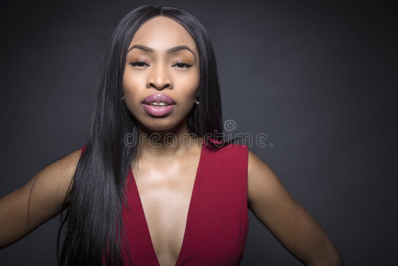 Black female model on a dark background with confident or snobby expressions. Black female model on a dark background with confident or snobby expressions.