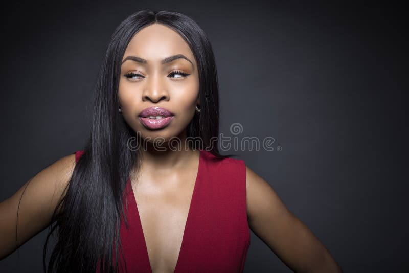 Black female model on a dark background with confident or snobby expressions. Black female model on a dark background with confident or snobby expressions.