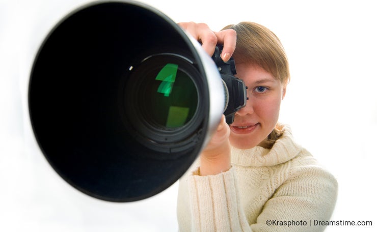 Woman photographer with big objective lens