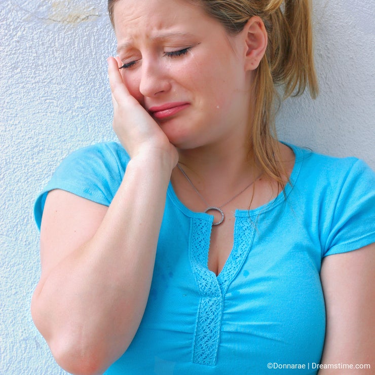 Sad young woman crying alone.