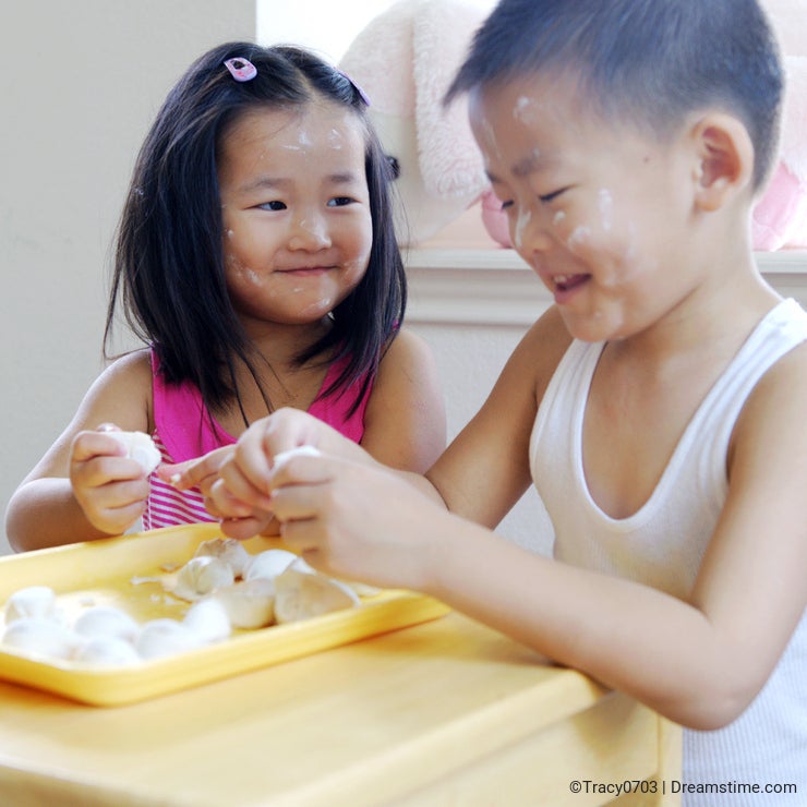 Brother and sister making dumplings