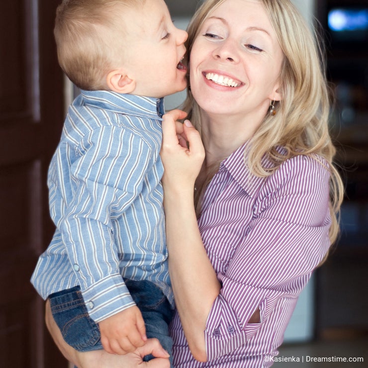 Happy family son kissing mother