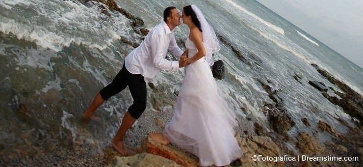 Seashore wedding (newlyweds couple in the sea)