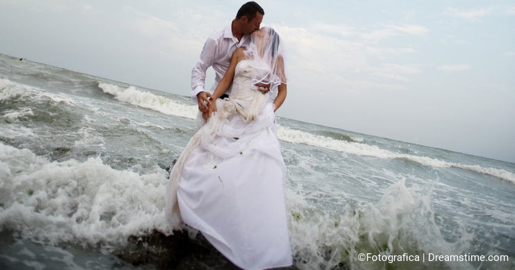 Bridal kiss (newlyweds couple kissing in the sea)