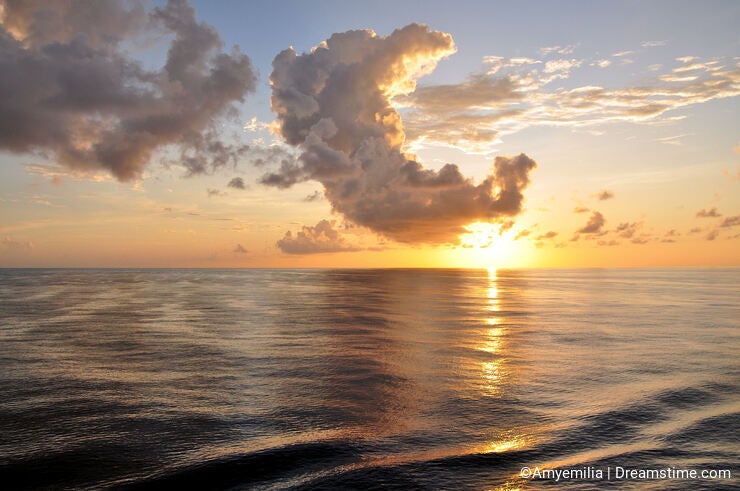 Tropical sunrise with clouds over ocean