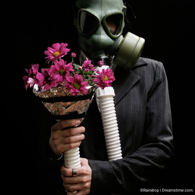 Girl with gas mask and flowers