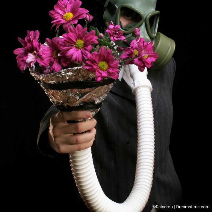 Girl with gas mask and flowers