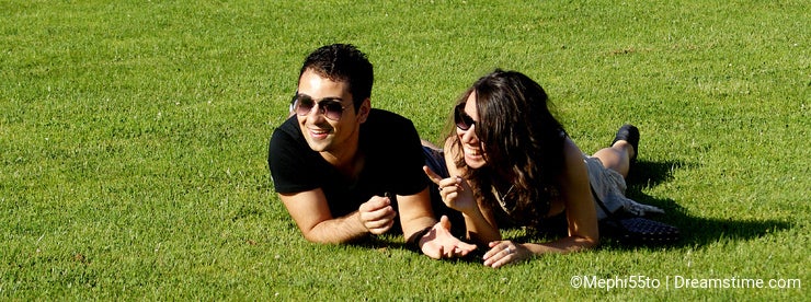 Happy young couple on field